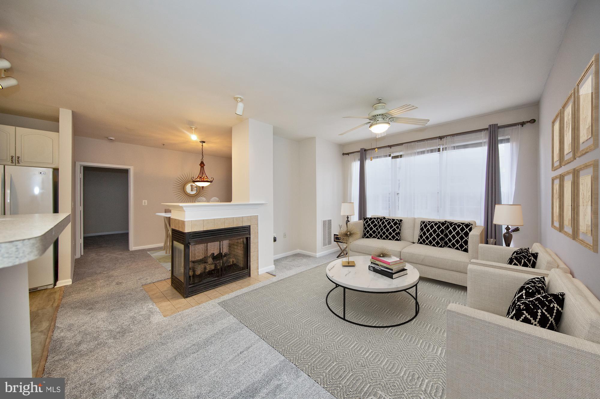 400 Symphony Circle, Unit 74B Cockeysville, MD 21030 - Photo 3 of 36 a living room with furniture and a fireplace