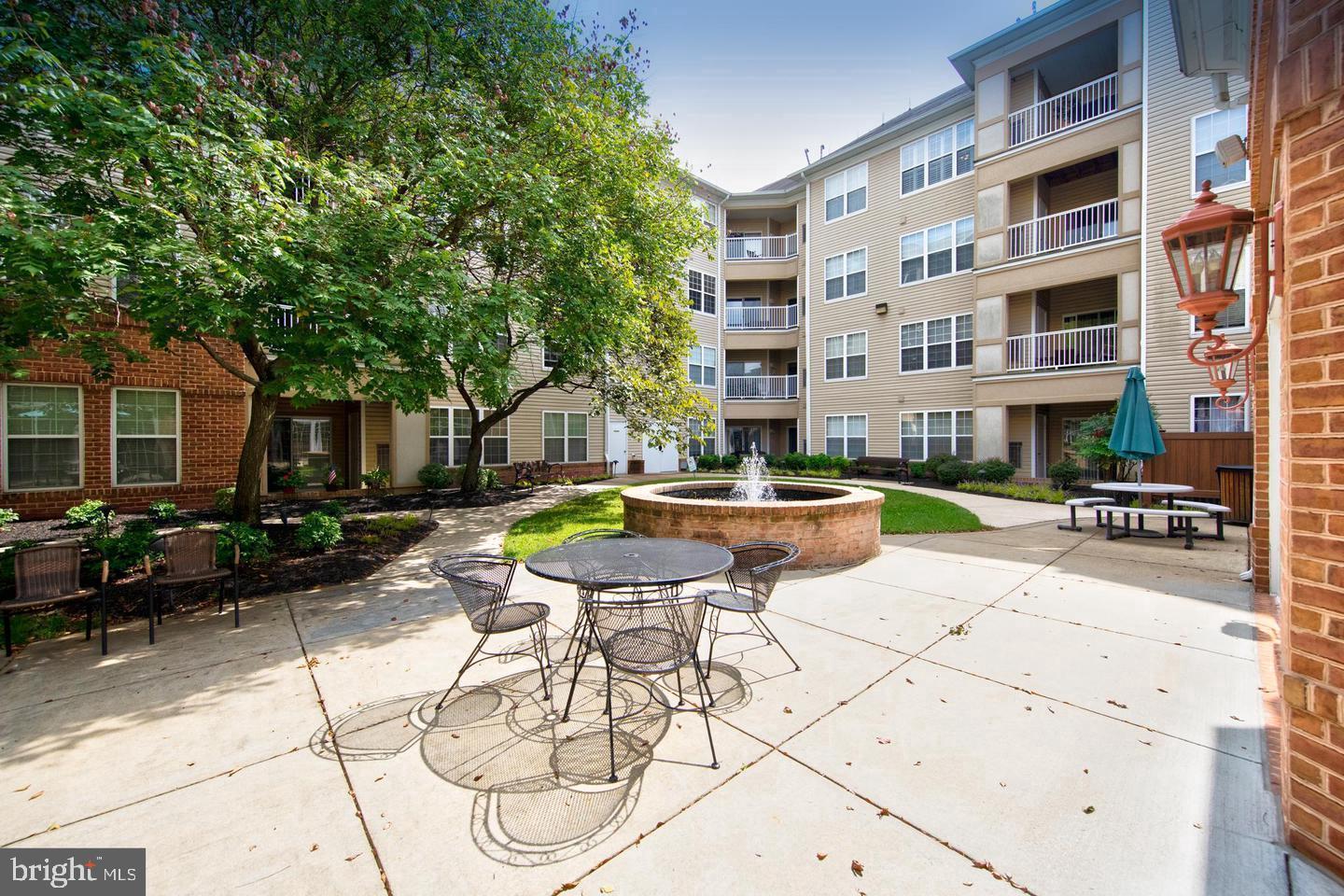 400 Symphony Circle, Unit 74B Cockeysville, MD 21030 - Photo 33 of 36 a view of a swimming pool with outdoor seating