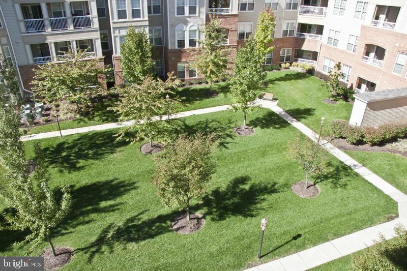 400 Symphony Circle, Unit 74B Cockeysville, MD 21030 - Photo 34 of 36 a view of a garden with a building