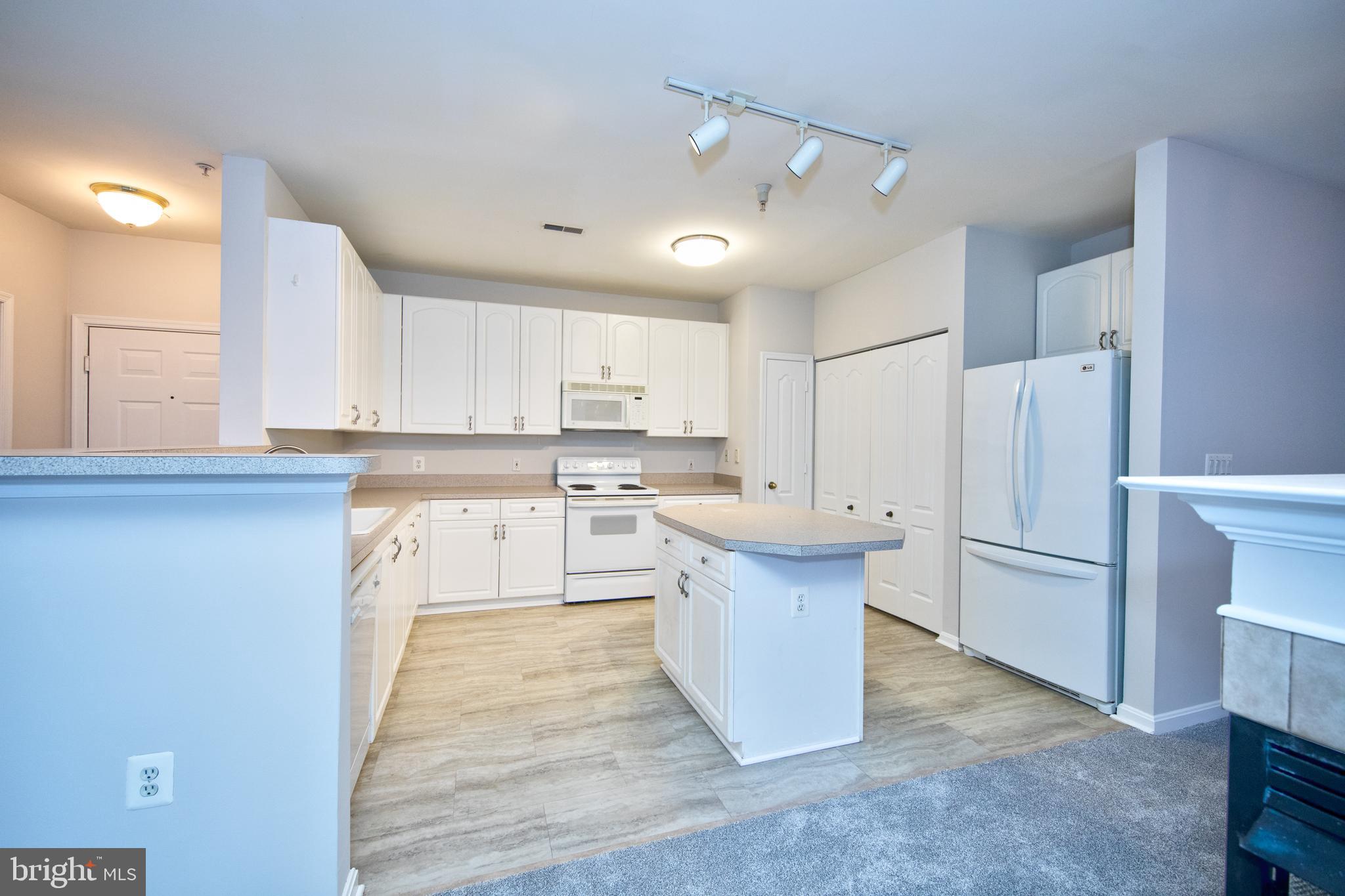 400 Symphony Circle, Unit 74B Cockeysville, MD 21030 - Photo 8 of 36 a kitchen with a refrigerator a sink and cabinets