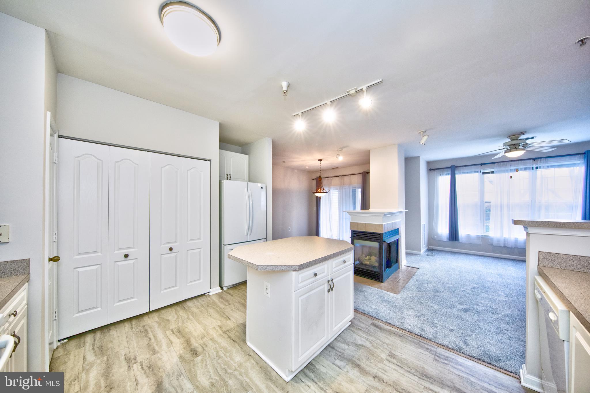 400 Symphony Circle, Unit 74B Cockeysville, MD 21030 - Photo 9 of 36 a large white kitchen with a large window
