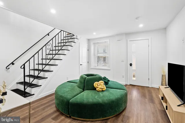 a view of livingroom with furniture stairs and wooden floor