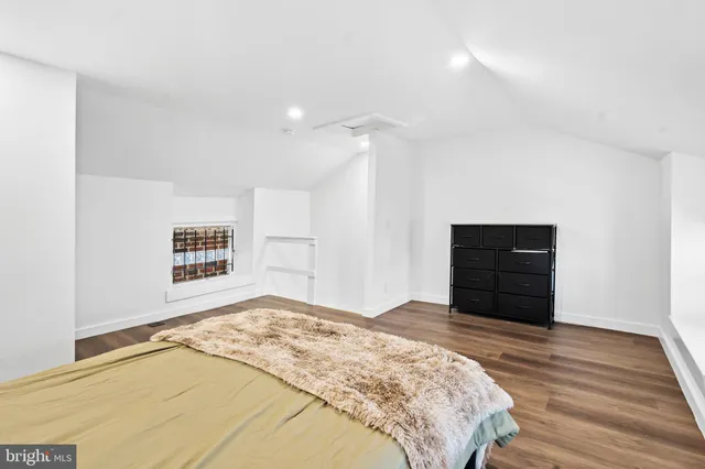 a bedroom with a bed and cabinets