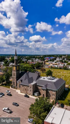a view of a city with lawn chairs and large trees