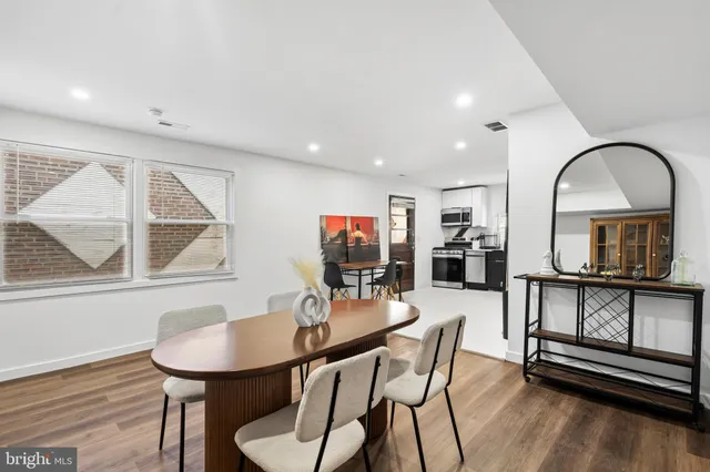 a dining room with furniture and wooden floor