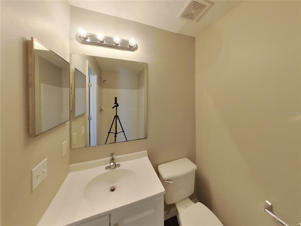 Undisclosed Address Spring Hill, FL 34608 - Photo 12 of 18 a bathroom with a toilet sink and mirror