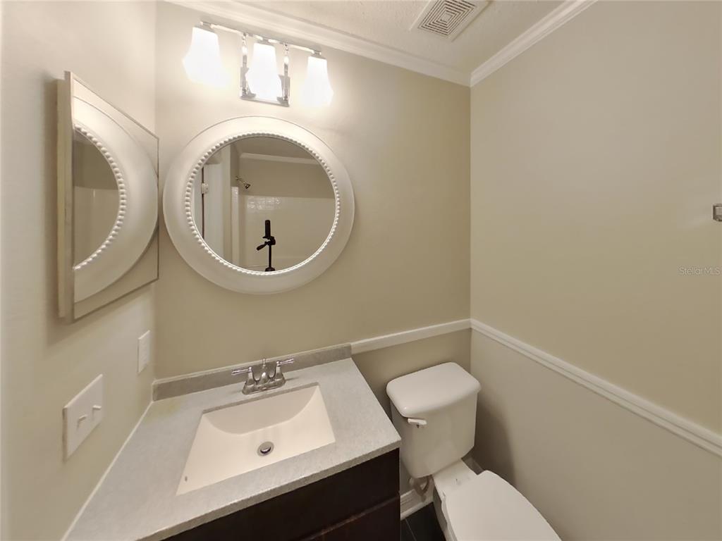 Undisclosed Address Spring Hill, FL 34608 - Photo 17 of 18 a bathroom with a sink mirror and toilet
