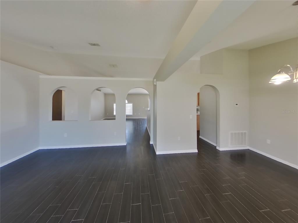 Undisclosed Address Spring Hill, FL 34608 - Photo 4 of 18 a view of a livingroom with wooden floor