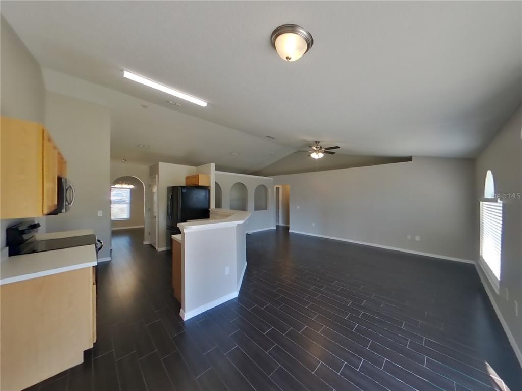 Undisclosed Address Spring Hill, FL 34608 - Photo 7 of 18 a view of living room with furniture and wooden floor