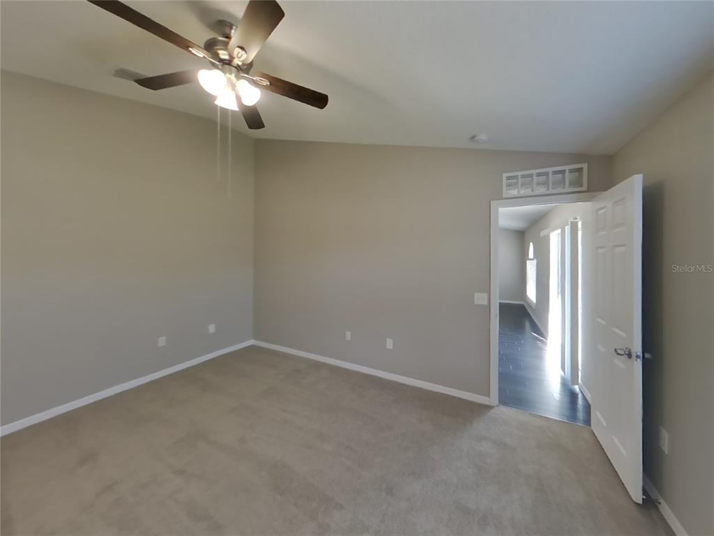 Undisclosed Address Spring Hill, FL 34608 - Photo 10 of 18 en empty room with windows and fan