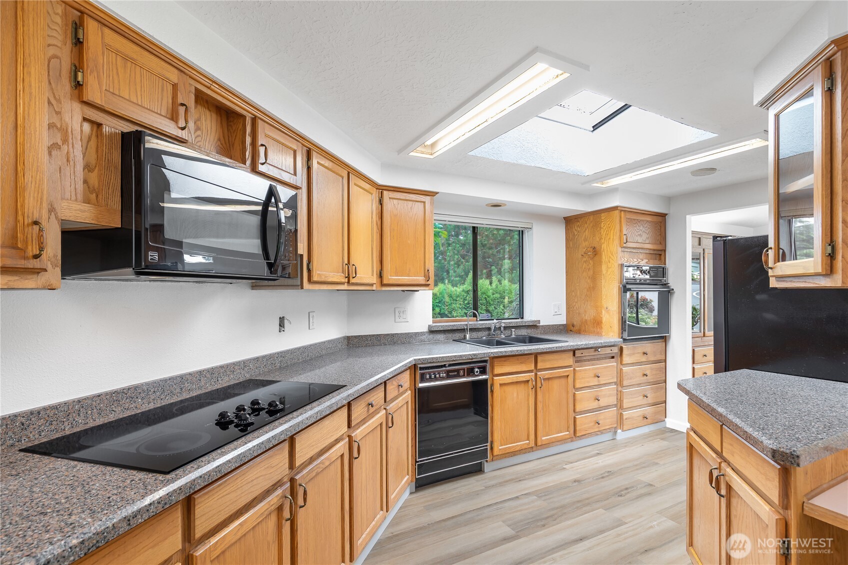 818 243rd Street Southwest Bothell, WA 98021 - Photo 13 of 40 a kitchen with stainless steel appliances granite countertop a stove a sink and a microwave
