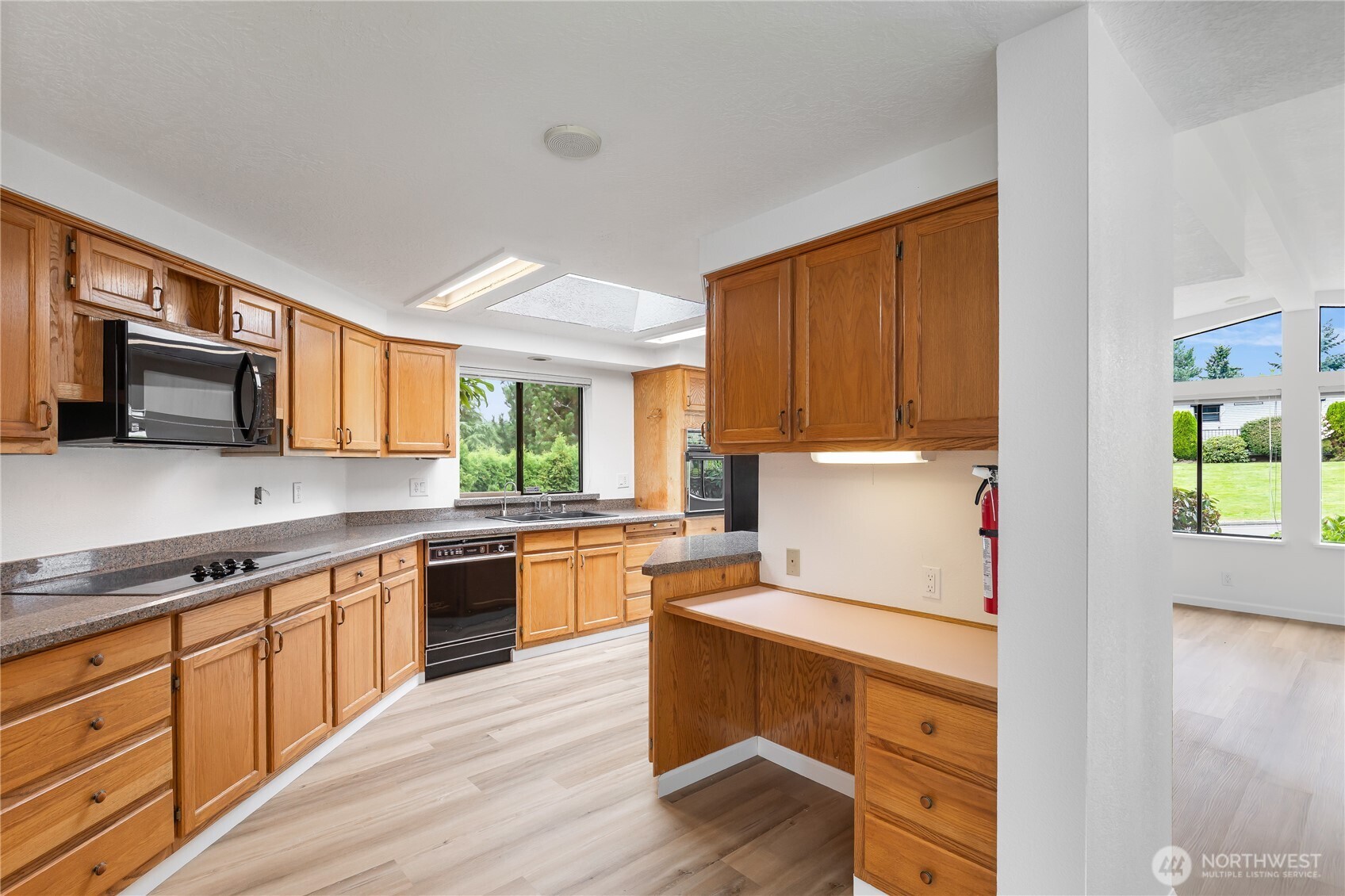 818 243rd Street Southwest Bothell, WA 98021 - Photo 15 of 40 a kitchen with granite countertop appliances cabinets and a wooden floor