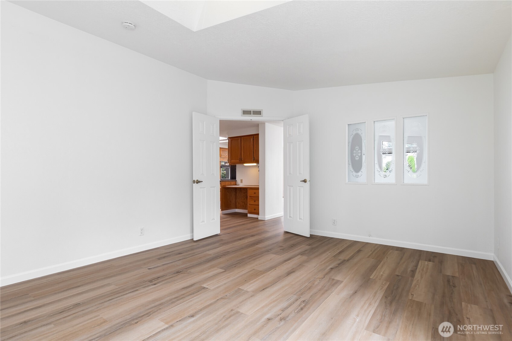 818 243rd Street Southwest Bothell, WA 98021 - Photo 17 of 40 an empty room with wooden floor and windows