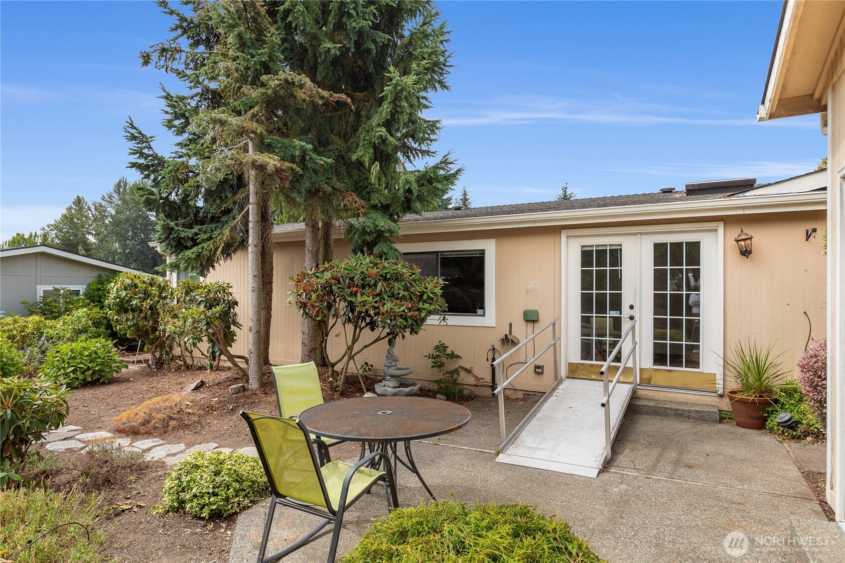 818 243rd Street Southwest Bothell, WA 98021 - Photo 29 of 40 a view of a house with backyard sitting area and garden