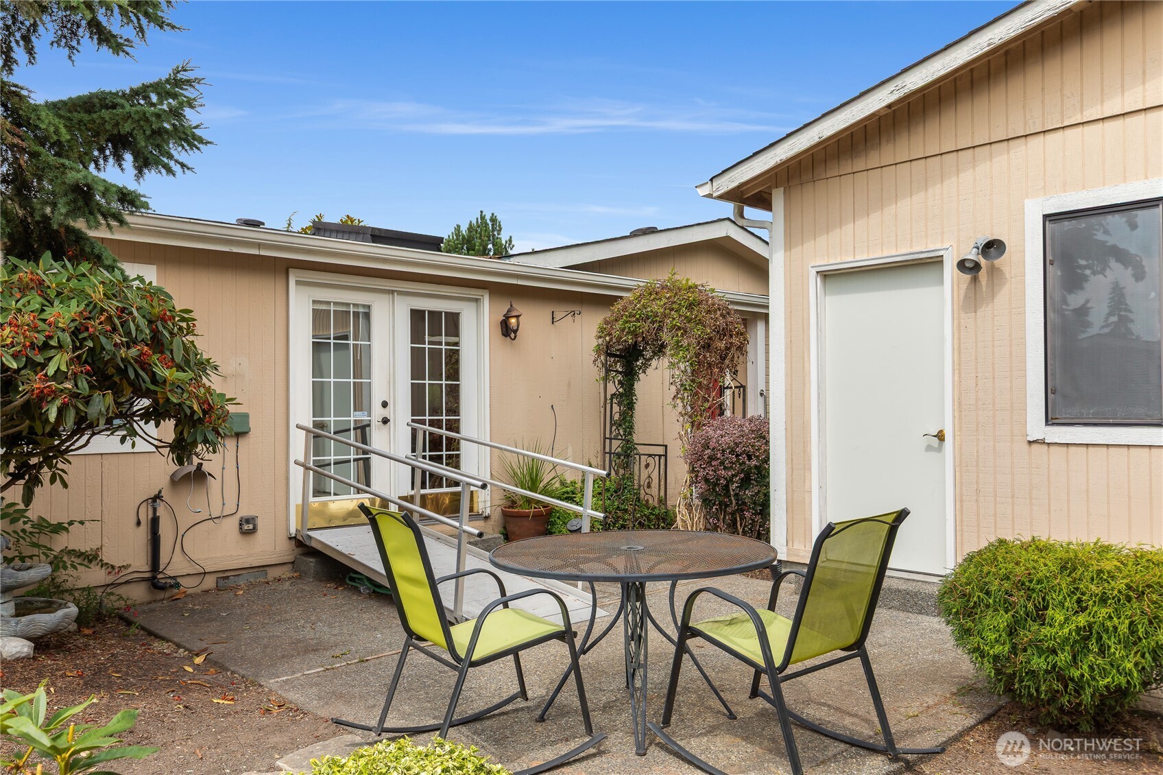 818 243rd Street Southwest Bothell, WA 98021 - Photo 30 of 40 a view of a patio with table and chairs and potted plants