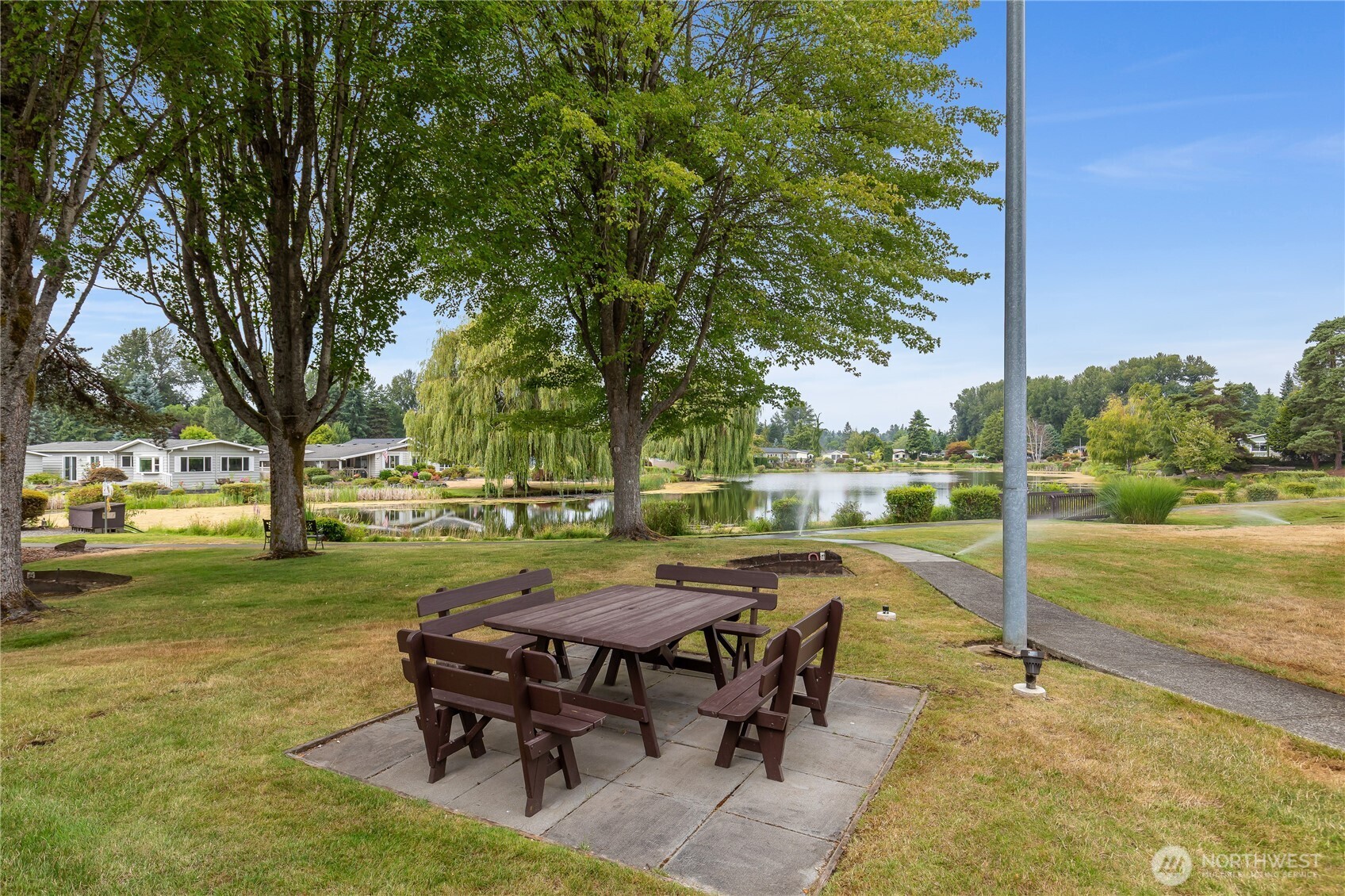 818 243rd Street Southwest Bothell, WA 98021 - Photo 33 of 40 a view of a swimming pool with lawn chairs and wooden fence