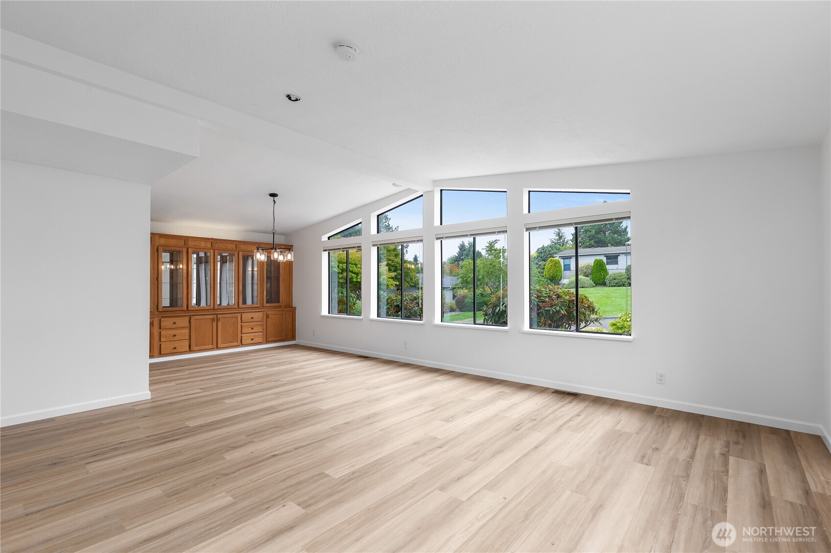 818 243rd Street Southwest Bothell, WA 98021 - Photo 6 of 40 a view of an empty room with wooden floor and a window
