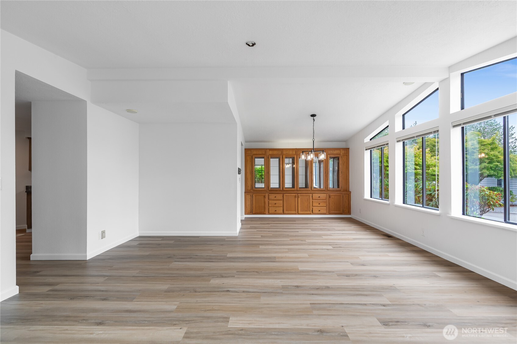 818 243rd Street Southwest Bothell, WA 98021 - Photo 7 of 40 a view of an empty room with a window and wooden floor