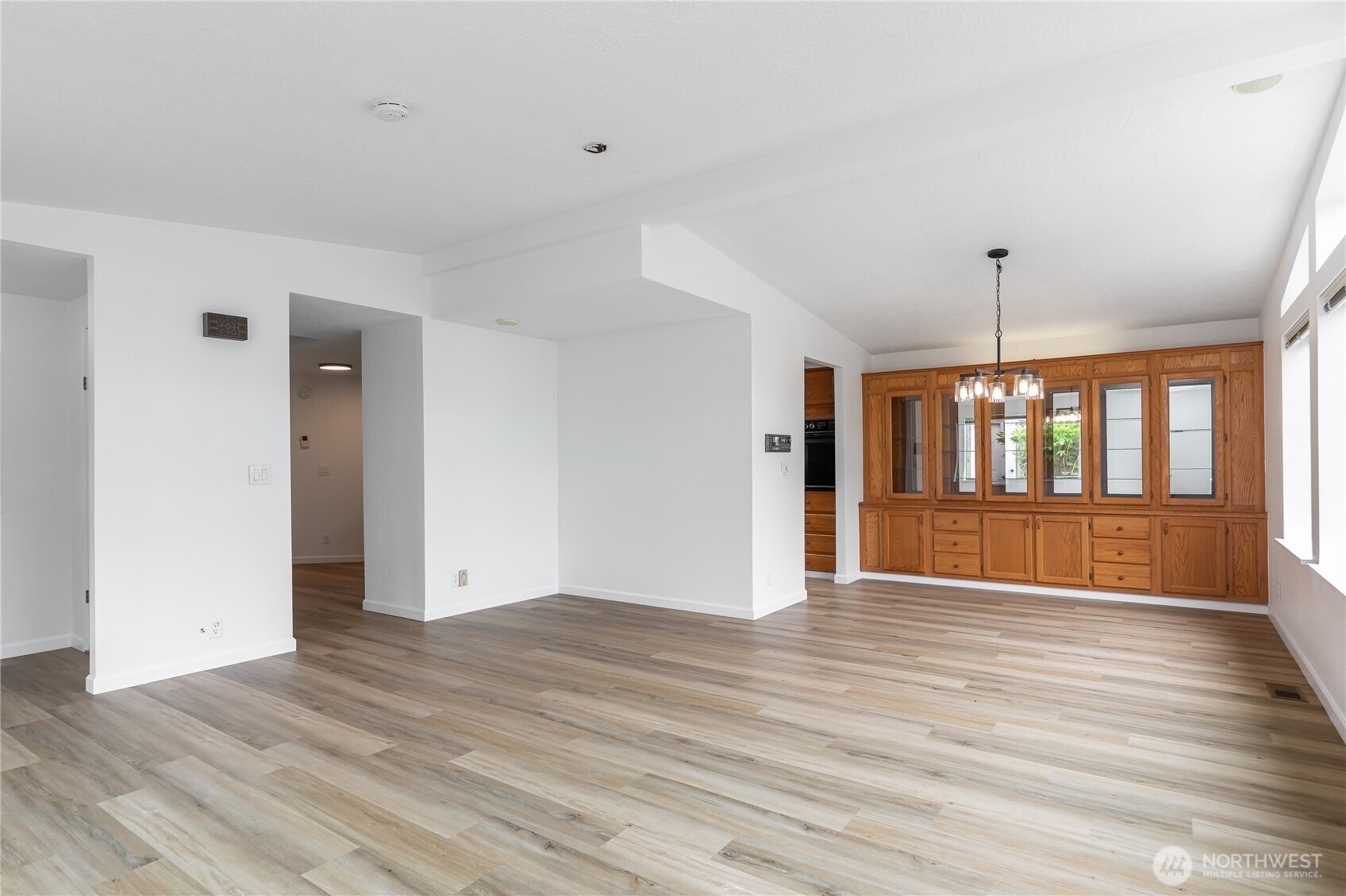 818 243rd Street Southwest Bothell, WA 98021 - Photo 8 of 40 a view of an empty room with wooden floor and a window