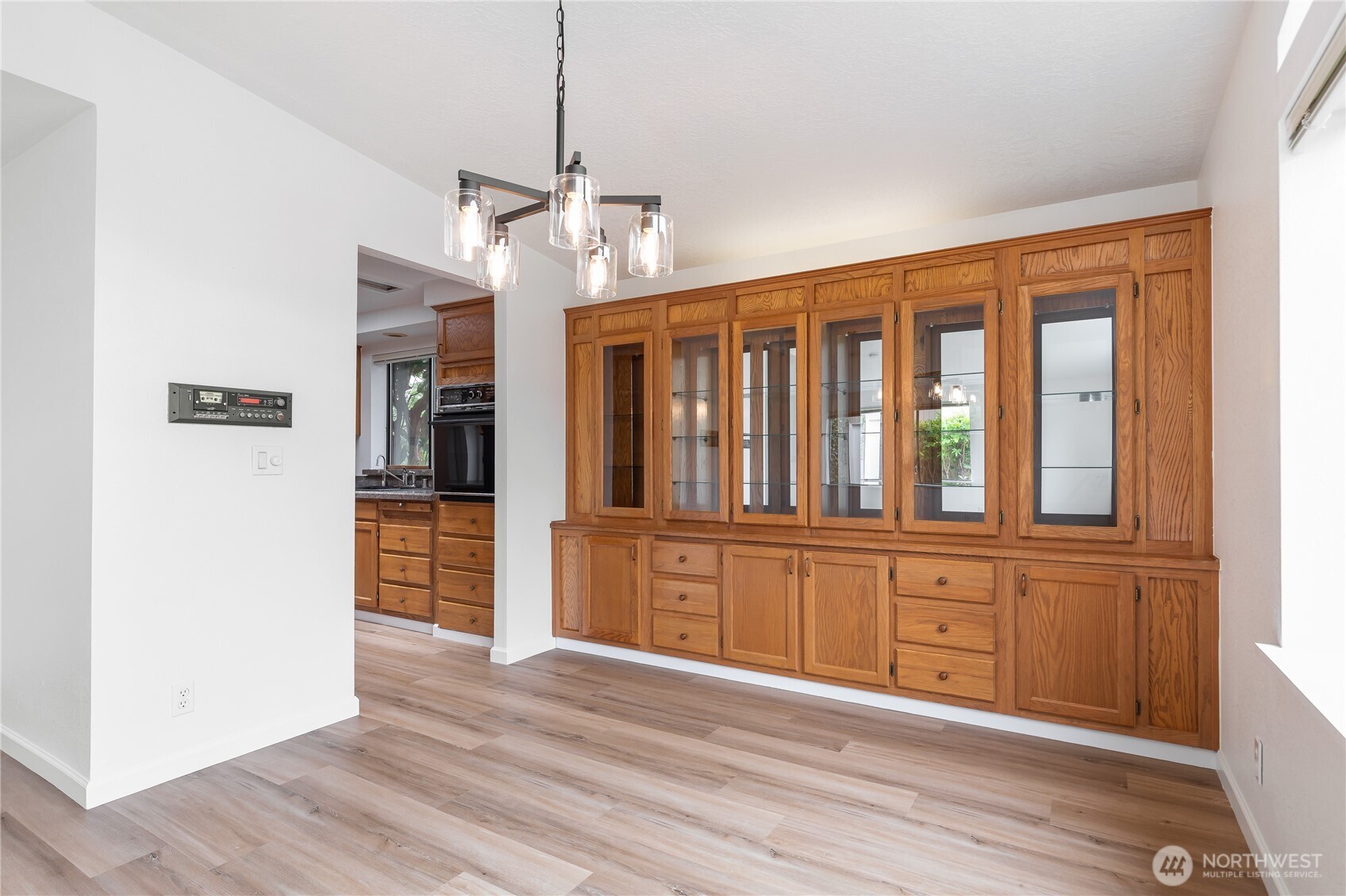 818 243rd Street Southwest Bothell, WA 98021 - Photo 9 of 40 a view of a kitchen with wooden floor a sink and a window