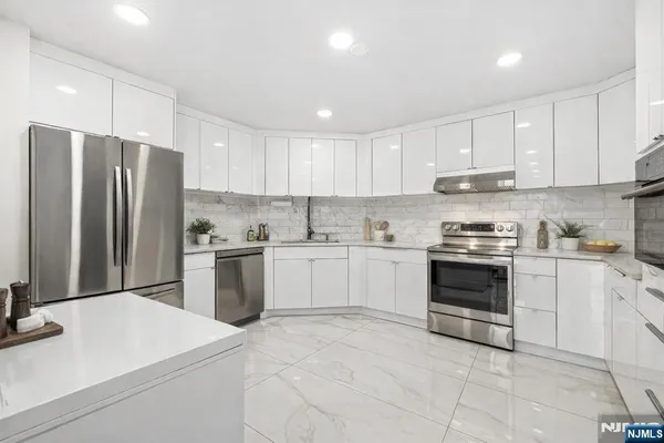 a kitchen with a white stove top oven and refrigerator