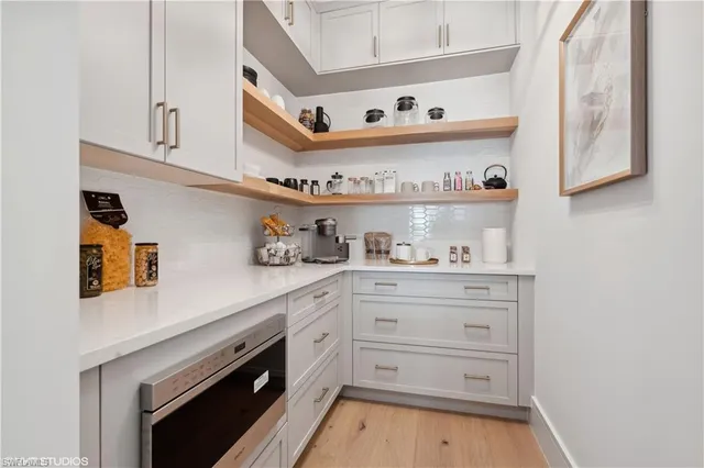 a kitchen with cabinets and window