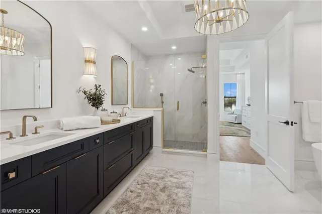 a spacious bathroom with a double vanity sink mirror and shower