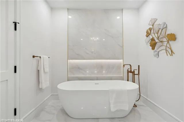 a bathroom with a bathtub and a shower