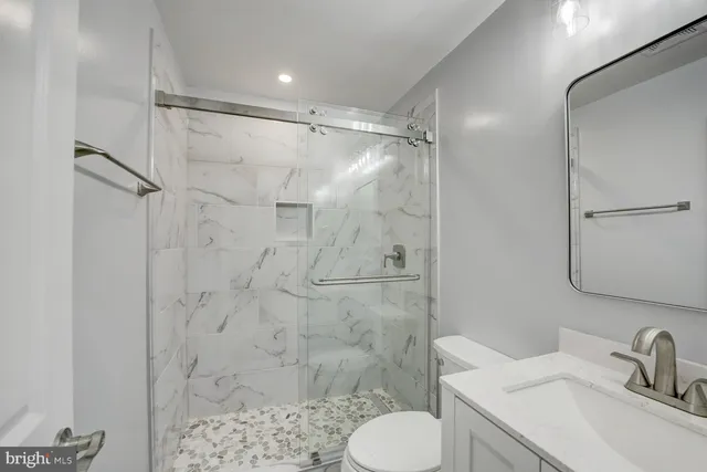 a bathroom with a sink toilet and shower