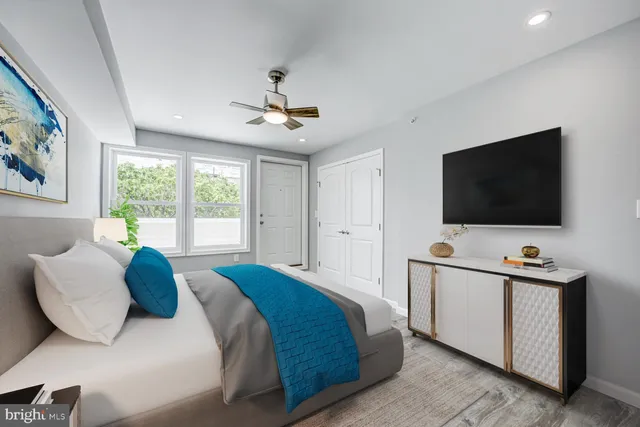 a bedroom with a bed and a flat screen tv