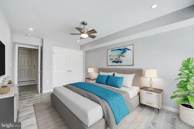 a bed room with a bed and a painting on the wall