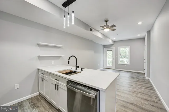 a kitchen that has a sink a stove and a window
