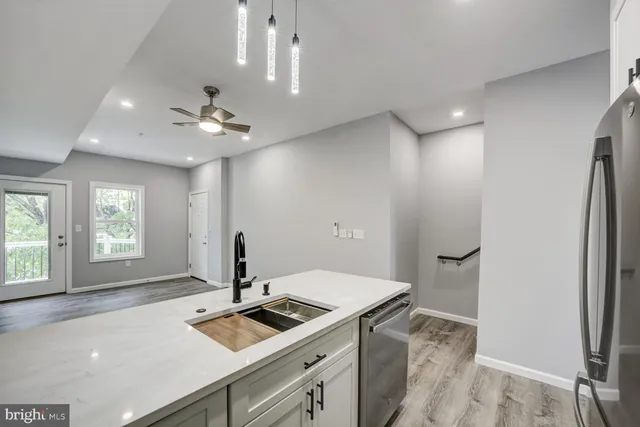 a kitchen with a sink appliances and cabinets