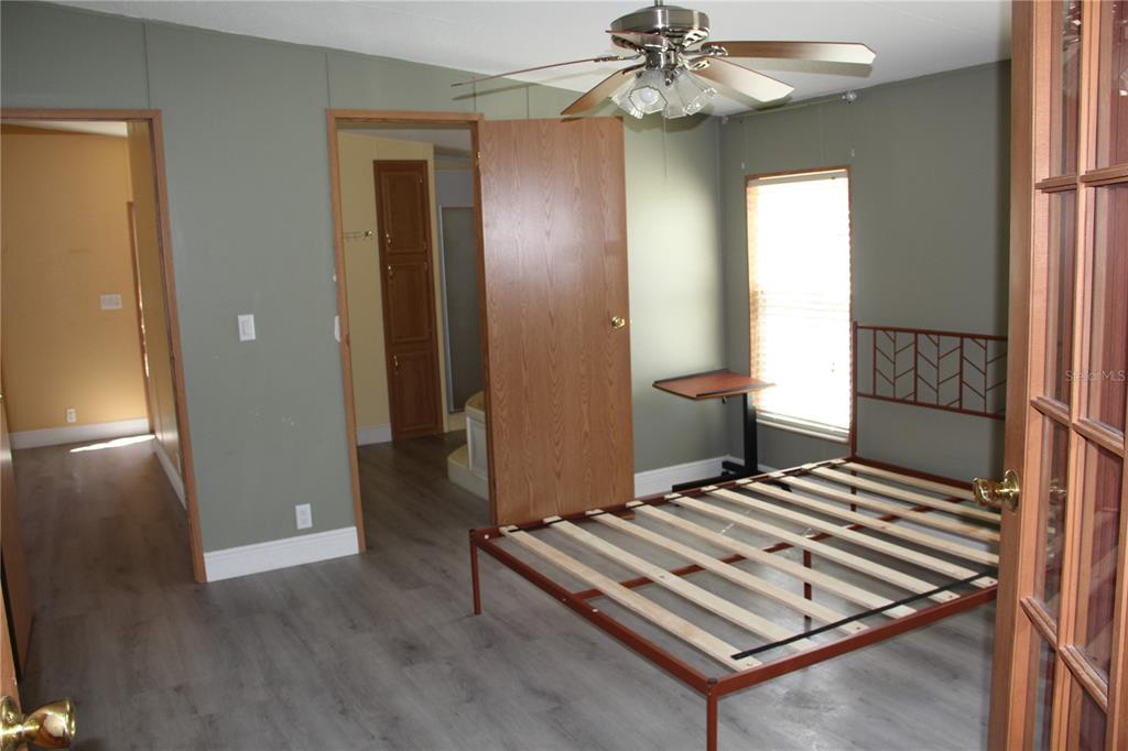 13201 Crowell Road Brooksville, FL 34613 - Photo 13 of 35 a view of a hallway with wooden floor and staircase