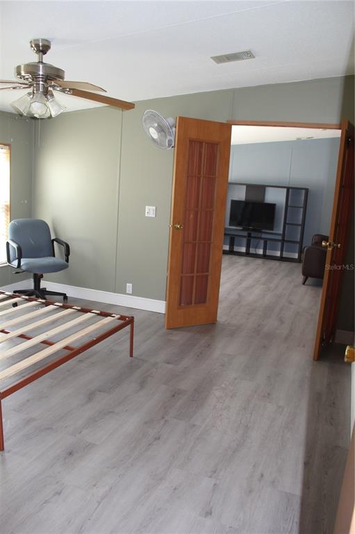 13201 Crowell Road Brooksville, FL 34613 - Photo 18 of 35 a living room with furniture and a chandelier
