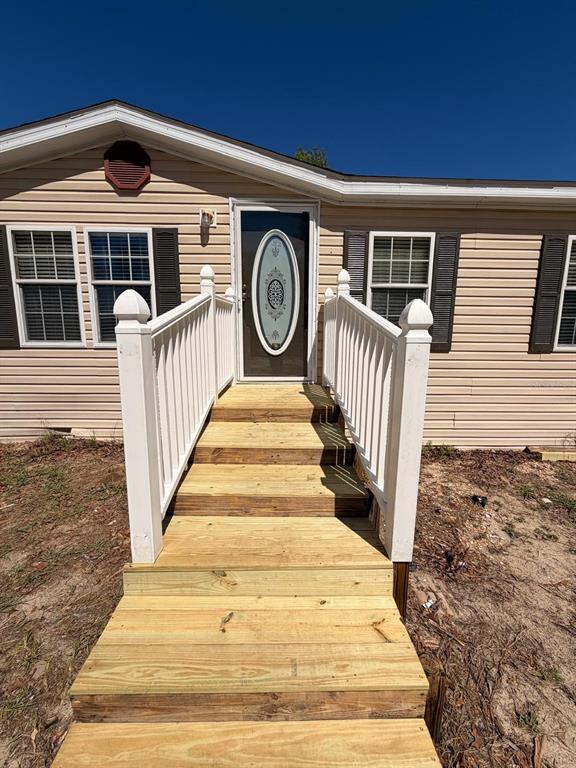 13201 Crowell Road Brooksville, FL 34613 - Photo 26 of 35 a front view of a house with a yard