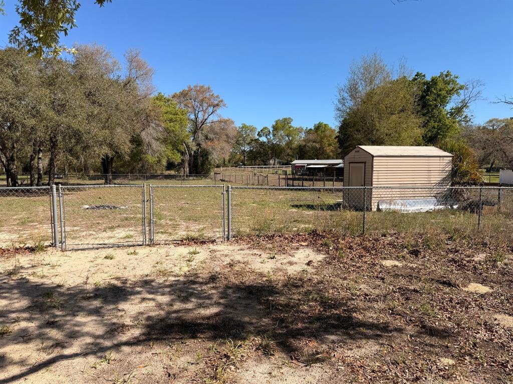 13201 Crowell Road Brooksville, FL 34613 - Photo 29 of 35 a view of a yard with wooden fence