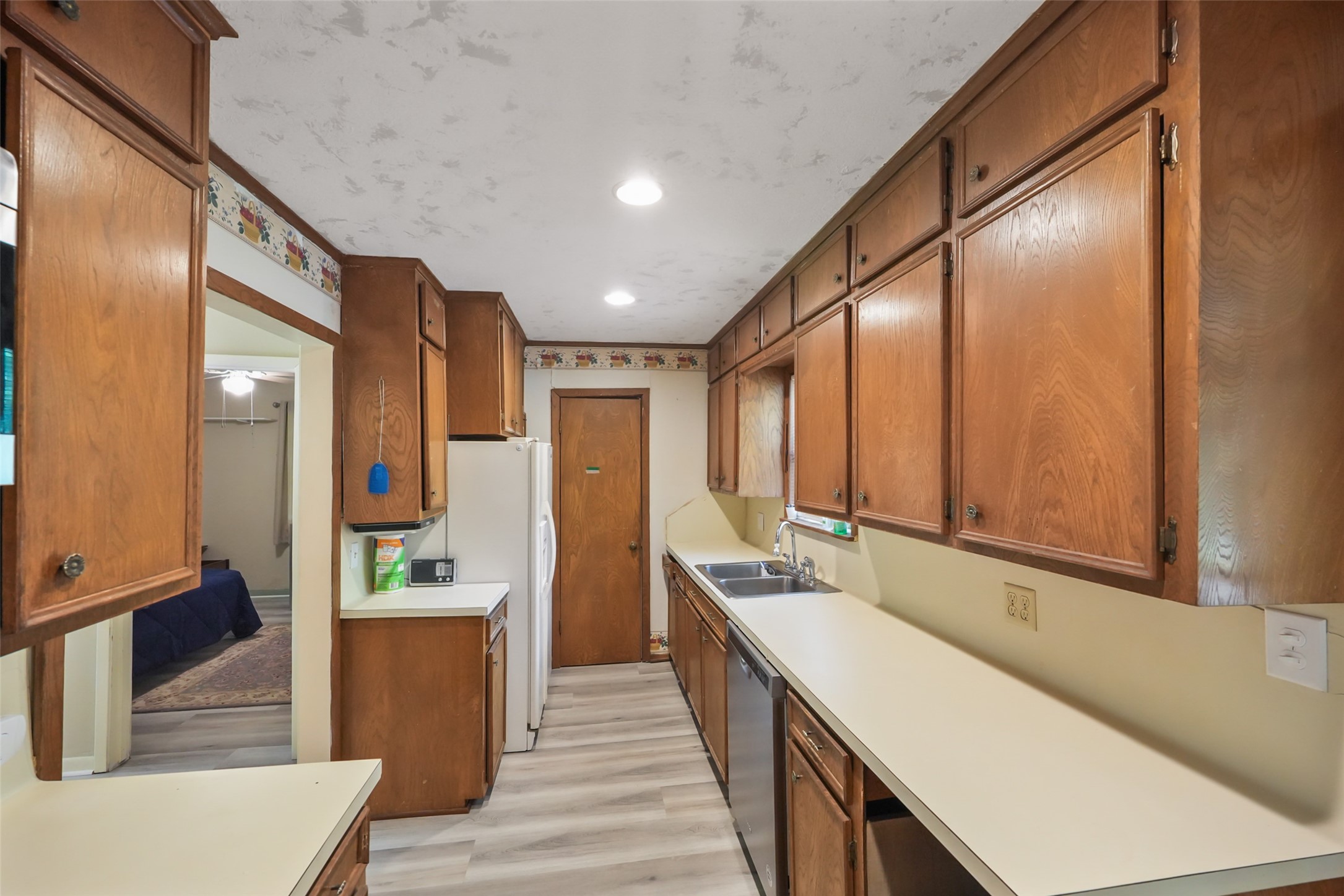 6387 Oak Knoll Road Montgomery, TX 77316 - Photo 13 of 30 a kitchen with stainless steel appliances a sink and cabinets