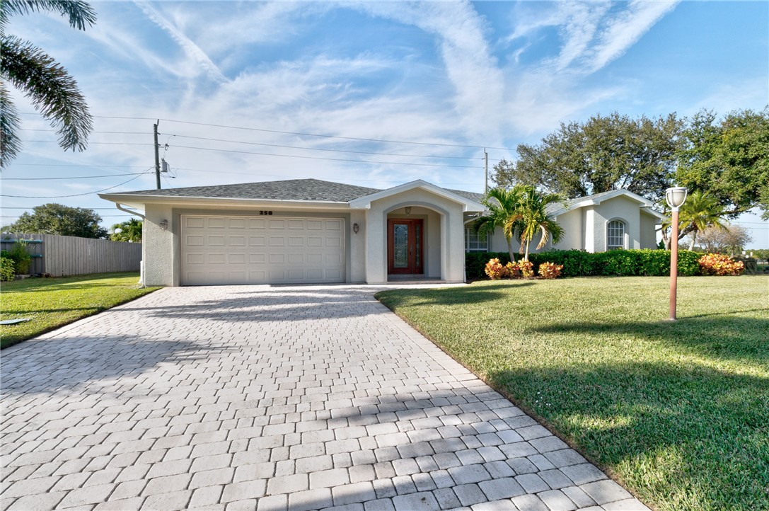 258 Main Street Sebastian, FL 32958 - Photo 1 of 32 a front view of a house with a yard and garage