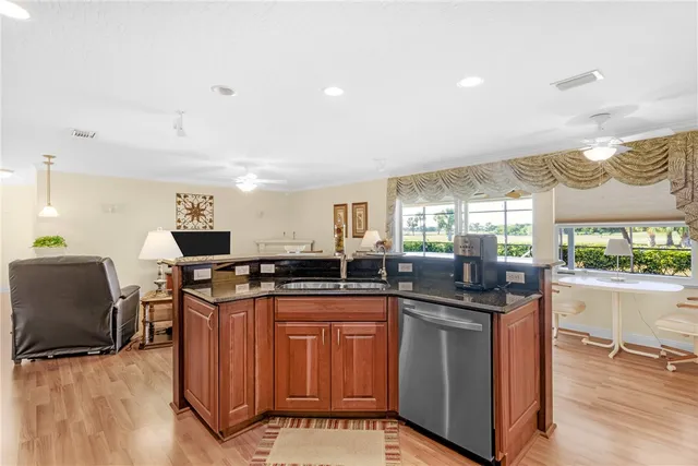 a kitchen with stainless steel appliances granite countertop a sink and cabinets