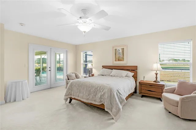 a spacious bedroom with a bed and a chandelier