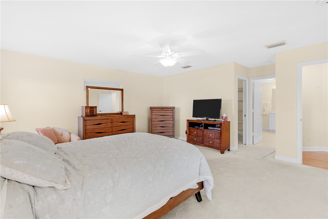 258 Main Street Sebastian, FL 32958 - Photo 15 of 32 a bedroom with a bed and a flat screen tv