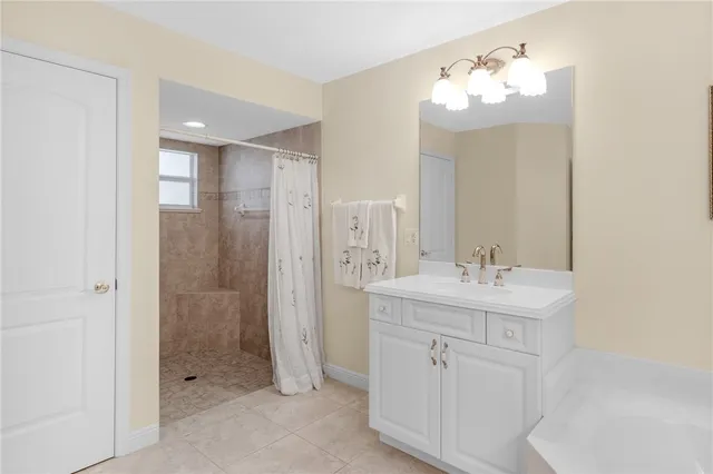 a bathroom with a double vanity sink mirror and shower
