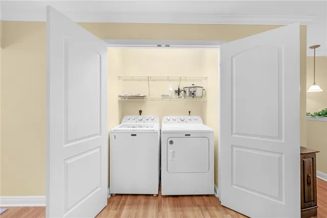 a view of washer and dryer with wooden floor