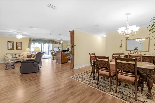 a view of a dining room with furniture wooden floor and chandelier