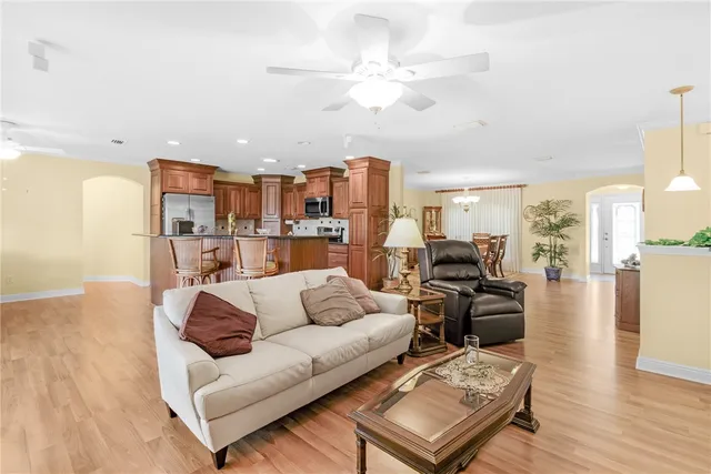 a living room with furniture and kitchen view