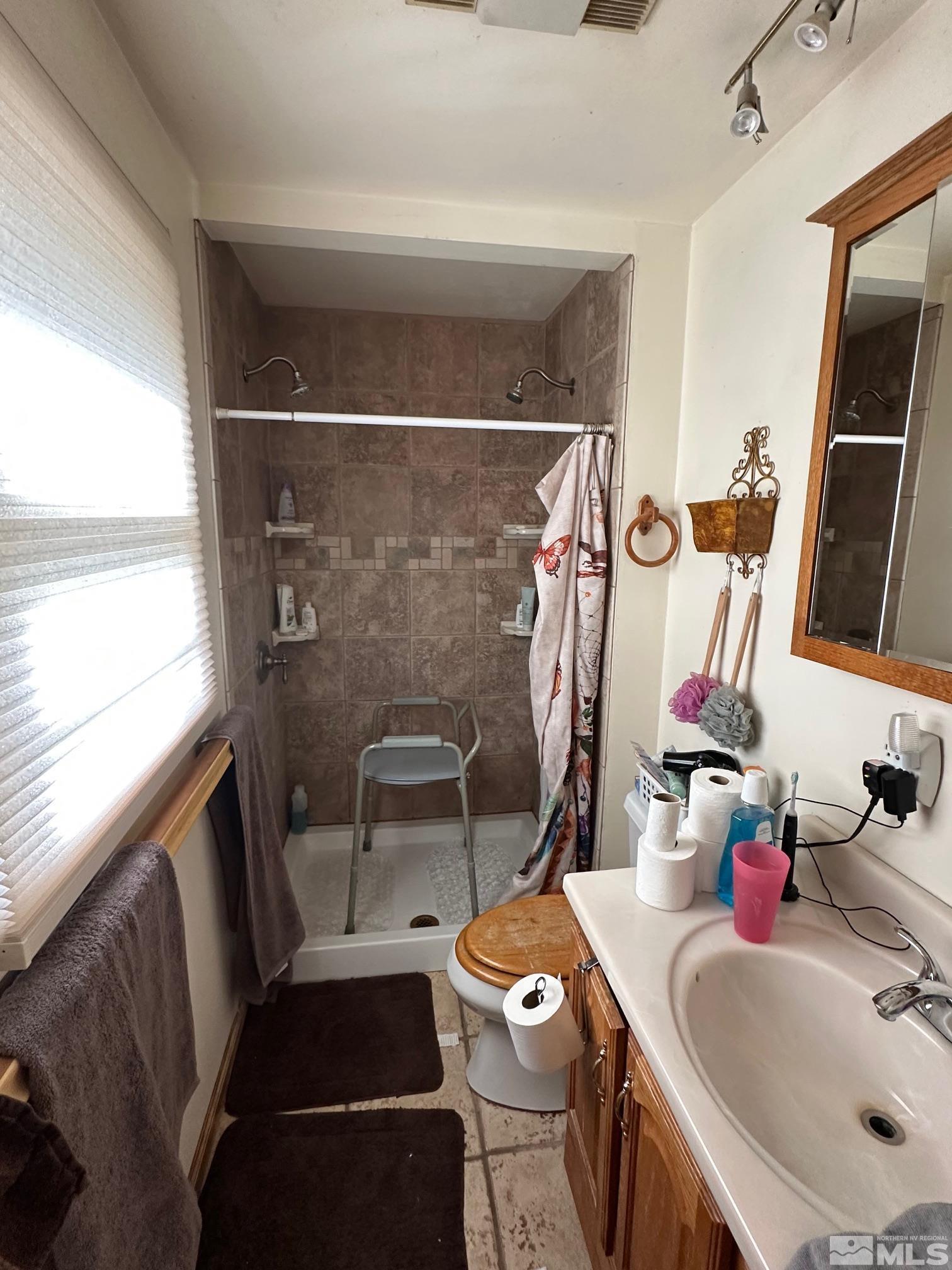 2391 Enterprise Road Reno, NV 89521 - Photo 11 of 15 a bathroom with a sink and a mirror