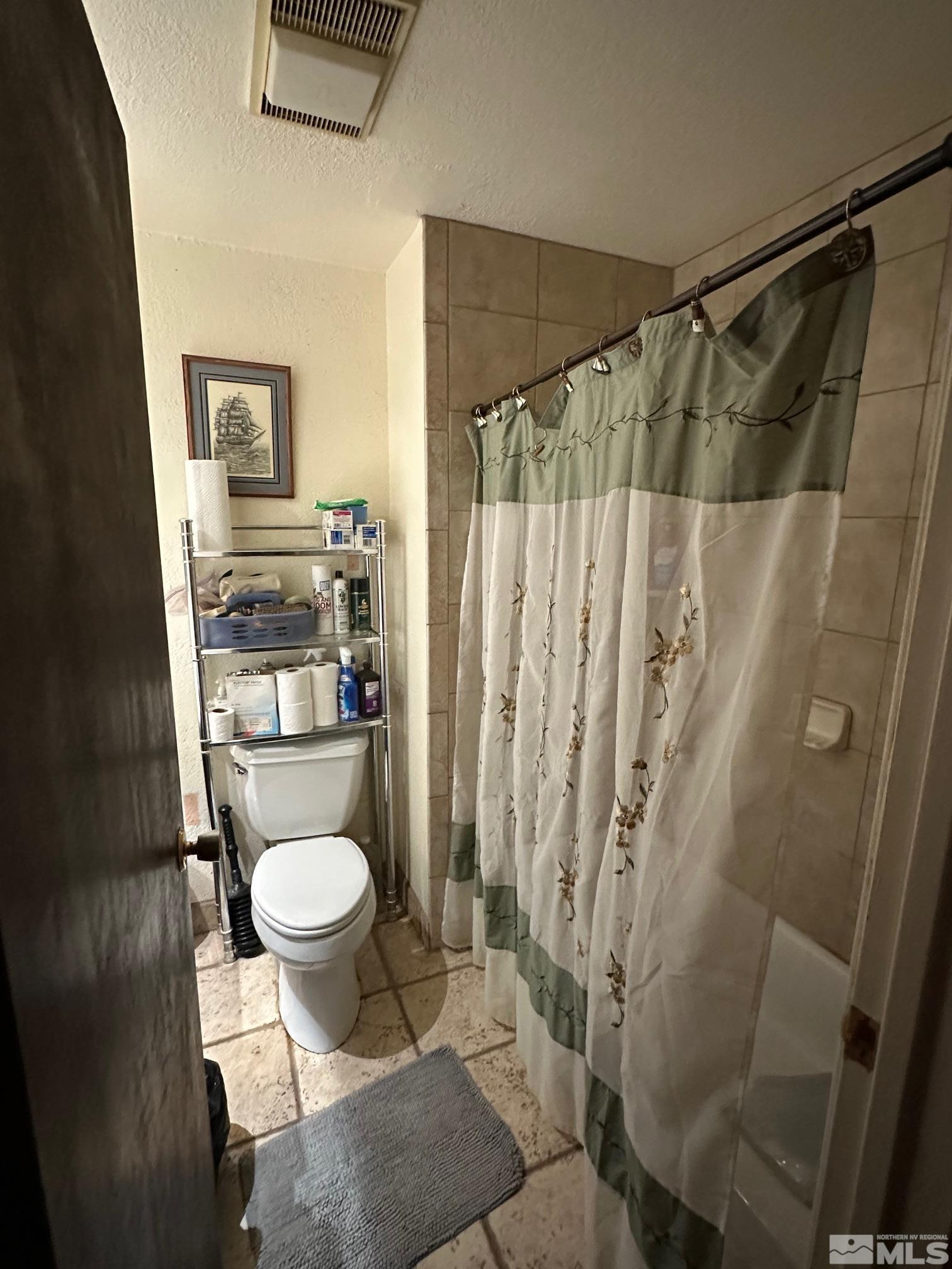 2391 Enterprise Road Reno, NV 89521 - Photo 13 of 15 a bathroom with a shower toilet and sink