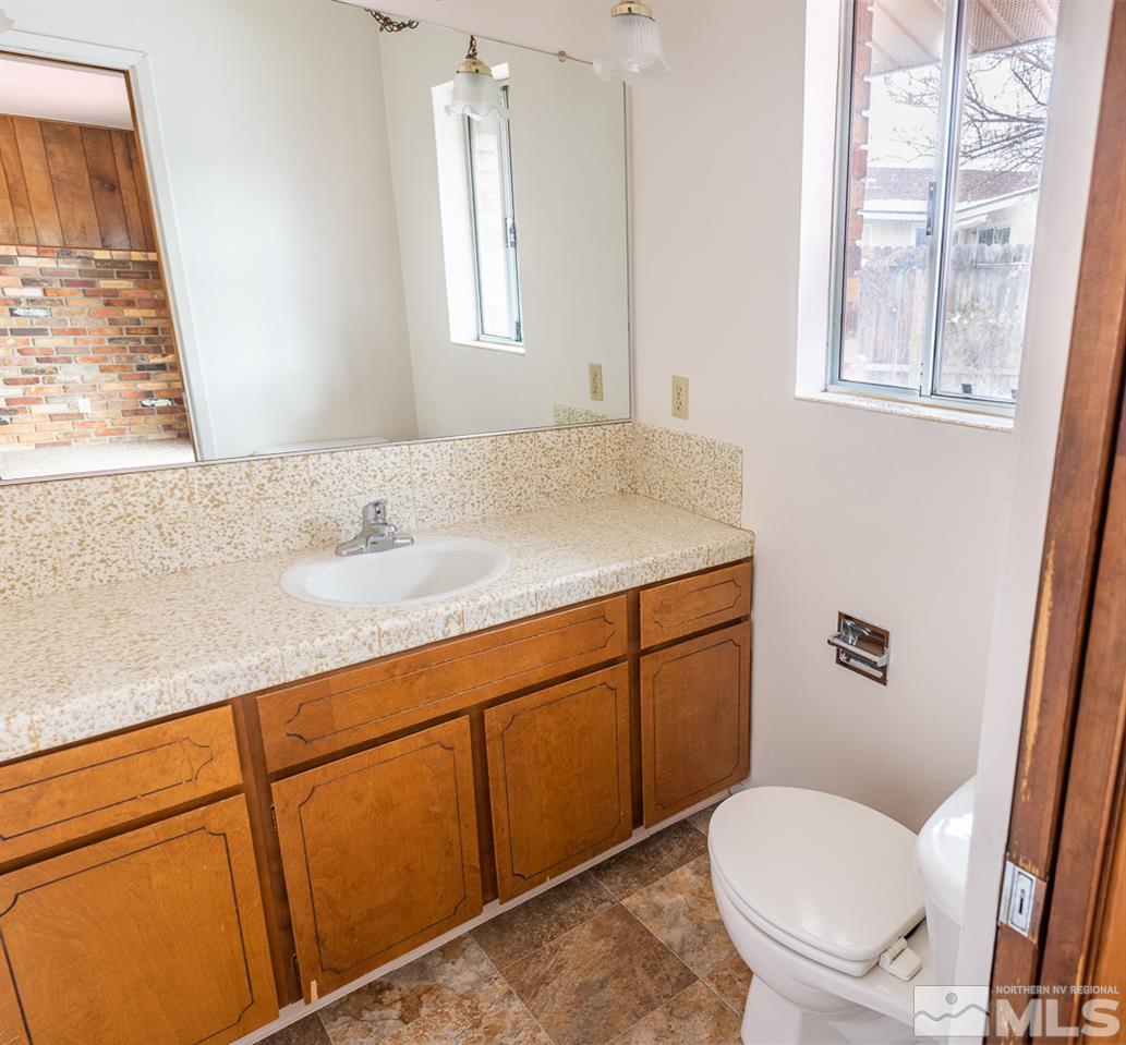 3255 Argo Way Reno, NV 89509 - Photo 11 of 25 a bathroom with a granite countertop sink toilet and mirror