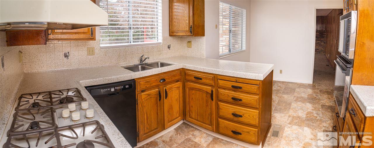 3255 Argo Way Reno, NV 89509 - Photo 13 of 25 a kitchen with stainless steel appliances granite countertop a stove and a sink